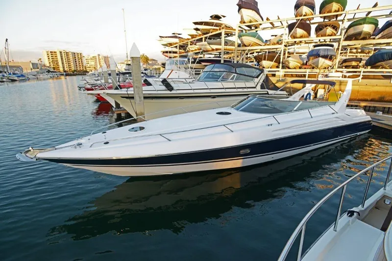 Slide: The Image of 1994 Sunseeker Apache 45 yacht docked in a marina, surrounded by other boats. - 1