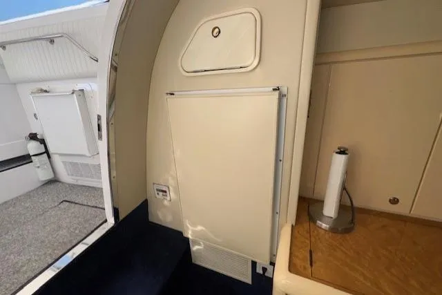 Slide: The Image of Interior view of a 1994 Sunseeker Apache 45 yacht, featuring a compact kitchenette area. - 18