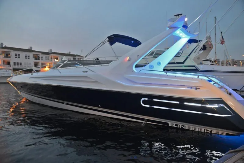 Slide: The Image of 1994 Sunseeker Apache 45 yacht docked at marina, illuminated with blue lights. - 2