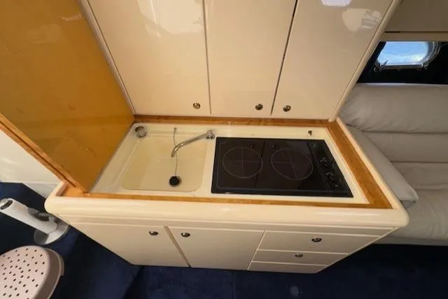 Slide: The Image of Compact kitchen area in a 1994 Sunseeker Apache 45 yacht with sink and stove. - 20