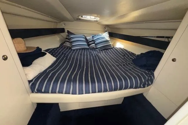 Slide: The Image of Interior cabin of 1994 Sunseeker Apache 45 with striped bedding and pillows. - 26