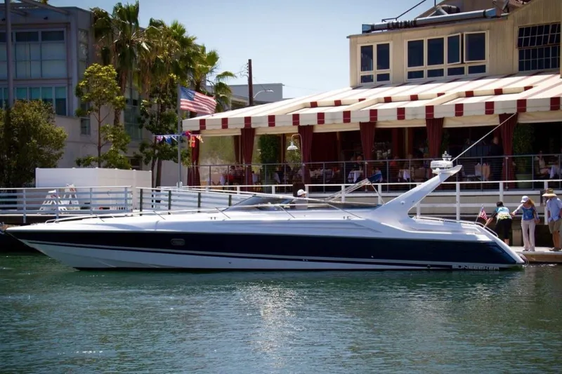 Slide: The Image of 1994 Sunseeker Apache 45 yacht docked by a waterfront restaurant. - 3