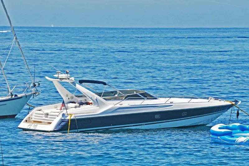 Slide: The Image of 1994 Sunseeker Apache 45 yacht anchored on calm blue waters. - 31