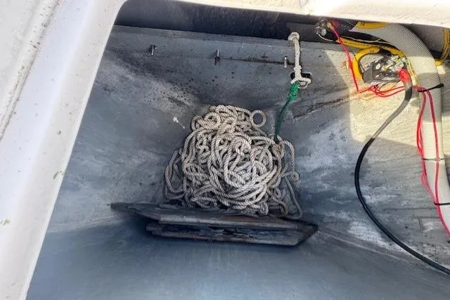 Slide: The Image of Anchor storage compartment of a 1994 Sunseeker Apache 45 with coiled rope and wiring. - 33