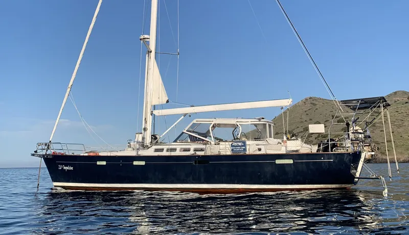 The Image of 2005 Beneteau 57 sailboat on calm water with scenic background. - 0