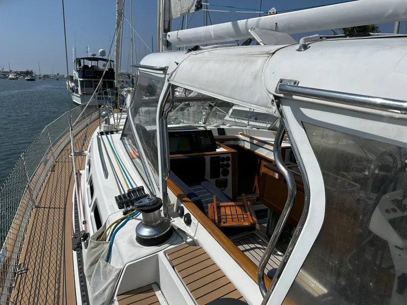 Slide: The Image of 2005 Beneteau 57 sailboat deck and cockpit view in marina. - 16