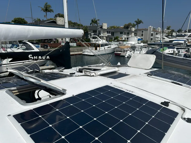 Slide: The Image of Beneteau 57 sailboat (2005) with solar panels docked in a marina. - 17