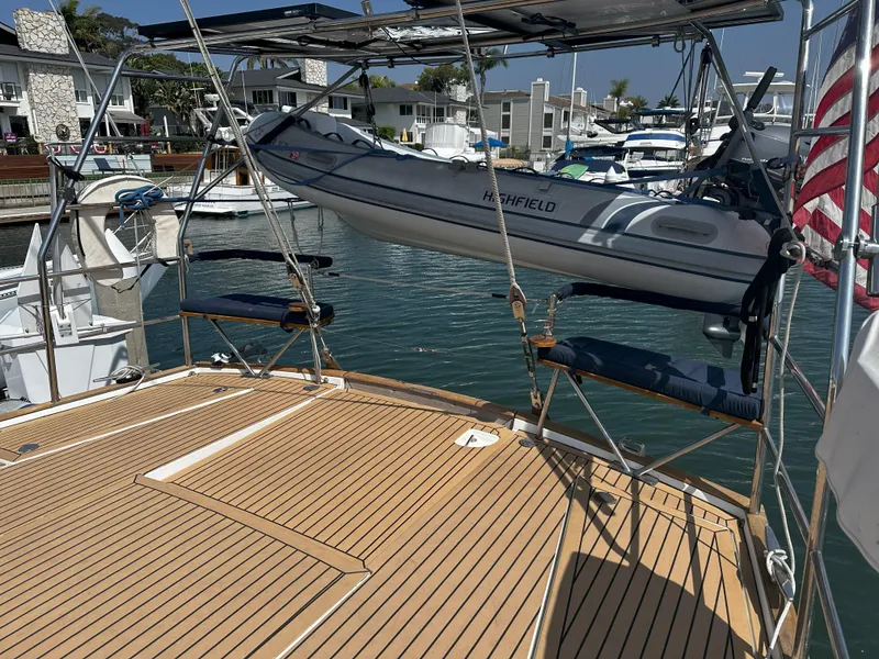 Slide: The Image of Beneteau 57 yacht deck with dinghy, docked in a marina, 2005 model. - 20