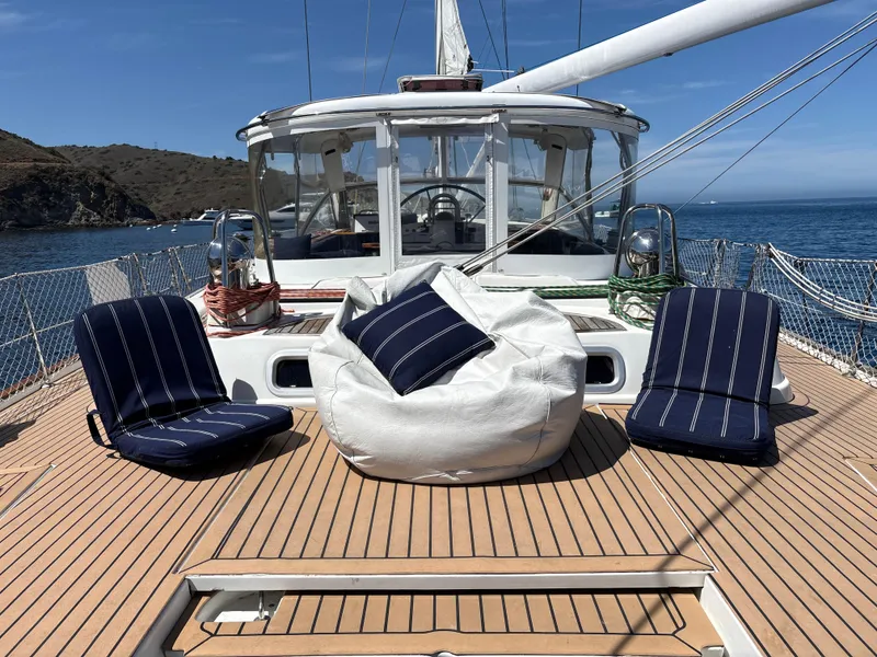 Slide: The Image of Deck of 2005 Beneteau 57 yacht with seating, ocean view, and clear sky. - 23