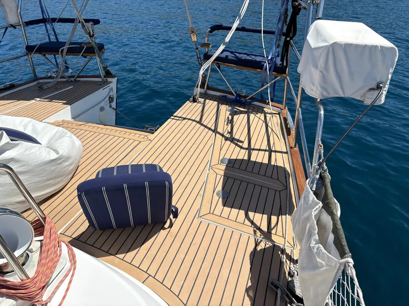 Slide: The Image of Deck of a 2005 Beneteau 57 yacht with seating, on calm blue water. - 24