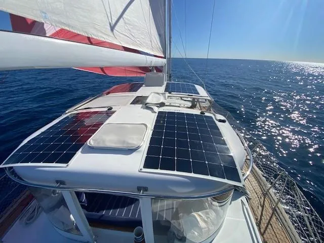 Slide: The Image of Sailing yacht Beneteau 57 (2005) with solar panels on deck, cruising in open sea. - 34