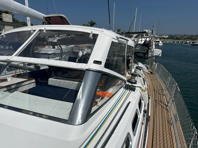 Slide: The Image of Beneteau 57 sailboat, 2005 model, docked at marina under clear blue sky. - 4