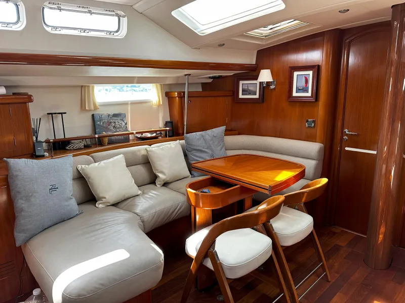 Slide: The Image of Luxurious interior of 2005 Beneteau 57 yacht with elegant wood finish and comfortable seating. - 43