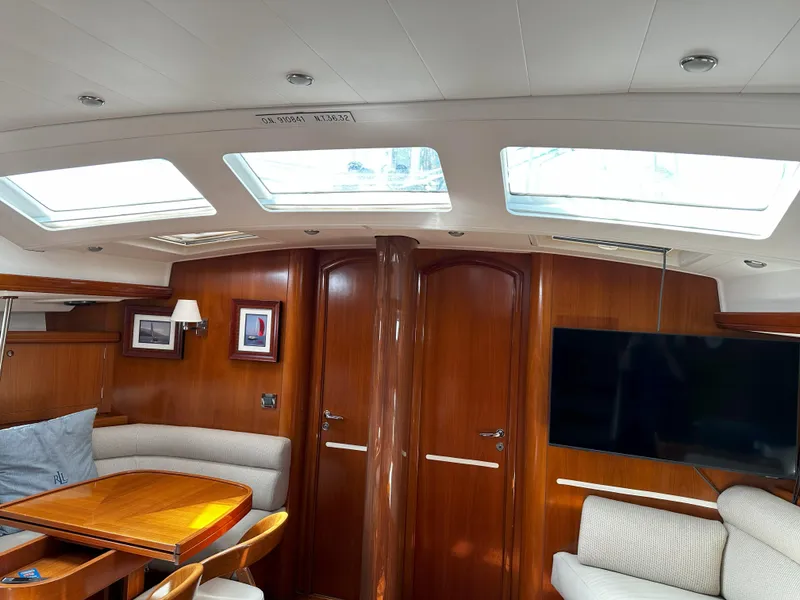 Slide: The Image of Luxurious interior of 2005 Beneteau 57 yacht with skylights and elegant wood finish. - 47