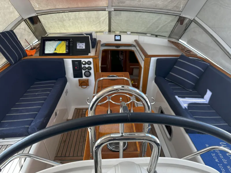 Slide: The Image of Interior view of 2005 Beneteau 57 sailboat cockpit with navigation equipment and seating. - 5