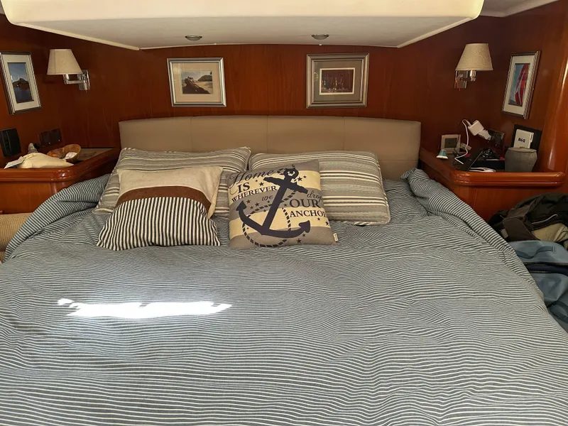 Slide: The Image of Luxurious bedroom interior of 2005 Beneteau 57 yacht with nautical-themed decor. - 52