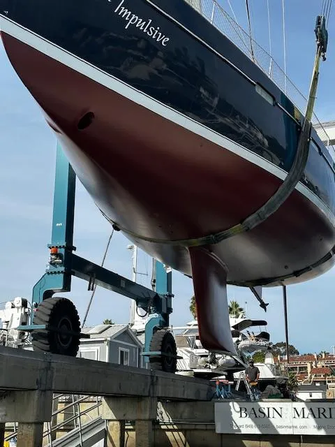 Slide: The Image of 2005 Beneteau 57 sailboat on lift at marina, hull view. - 65