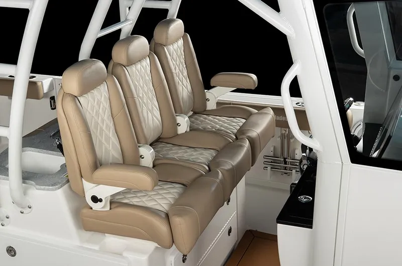 Slide: The Image of Manufacturer Provided Image: Luxurious seating on 2025 Everglades 335 Center Console boat, featuring beige leather upholstery. - 7