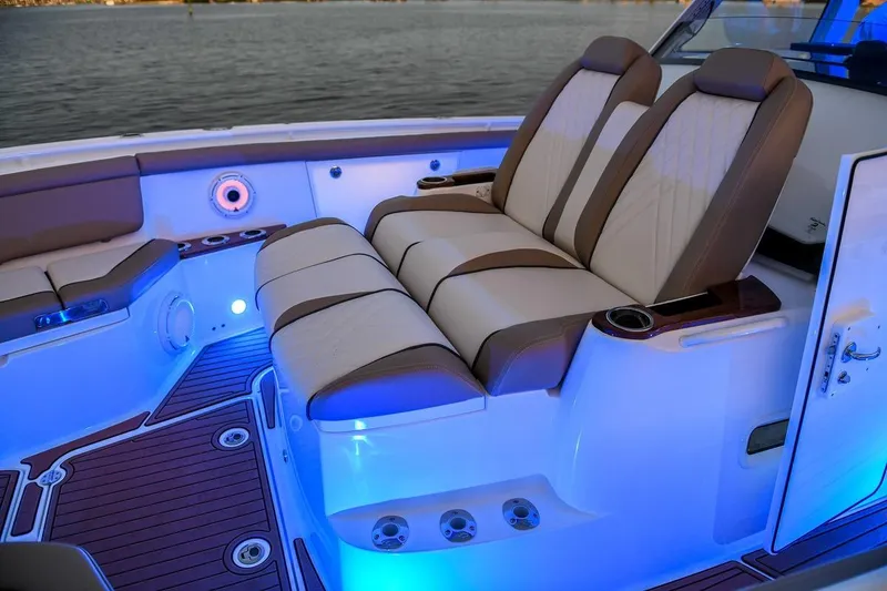 Slide: The Image of Luxurious seating on 2026 Everglades 395 Center Console boat with ambient blue lighting. - 10
