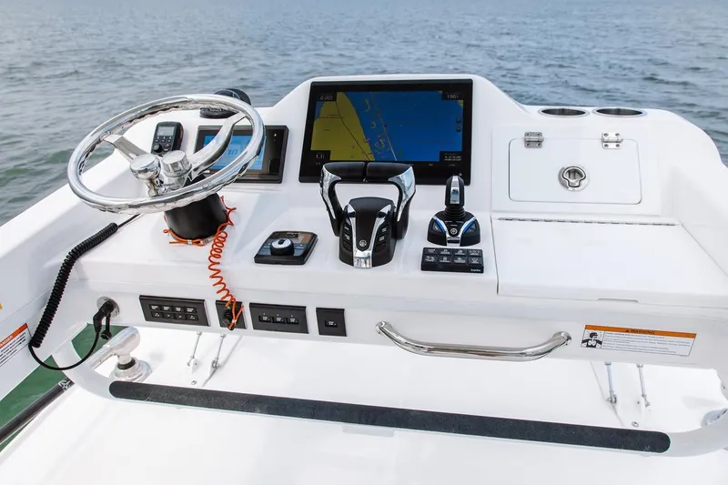Slide: The Image of 2026 Everglades 395 Center Console boat dashboard with navigation and control systems. - 12