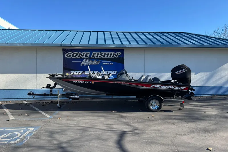 The Image of 2017 Tracker Pro Team 195 TXW boat parked outside a marine shop. - 1