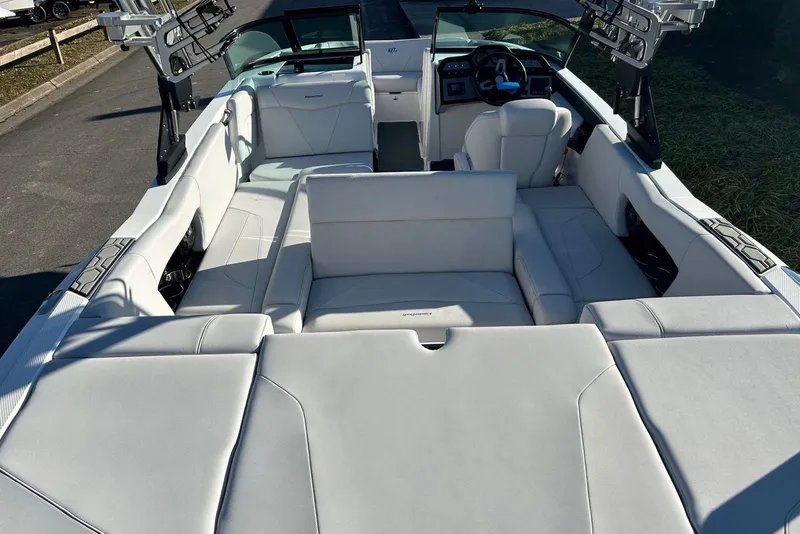 Slide: The Image of 2020 MasterCraft NXT22 boat interior with white seating and modern dashboard. - 14