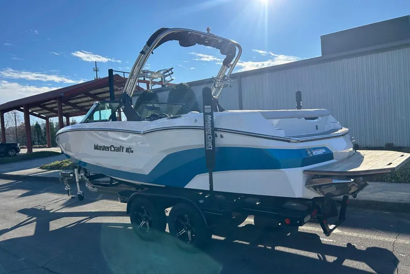 Slide: The Image of 2020 MasterCraft NXT22 boat on trailer under sunny sky. - 5