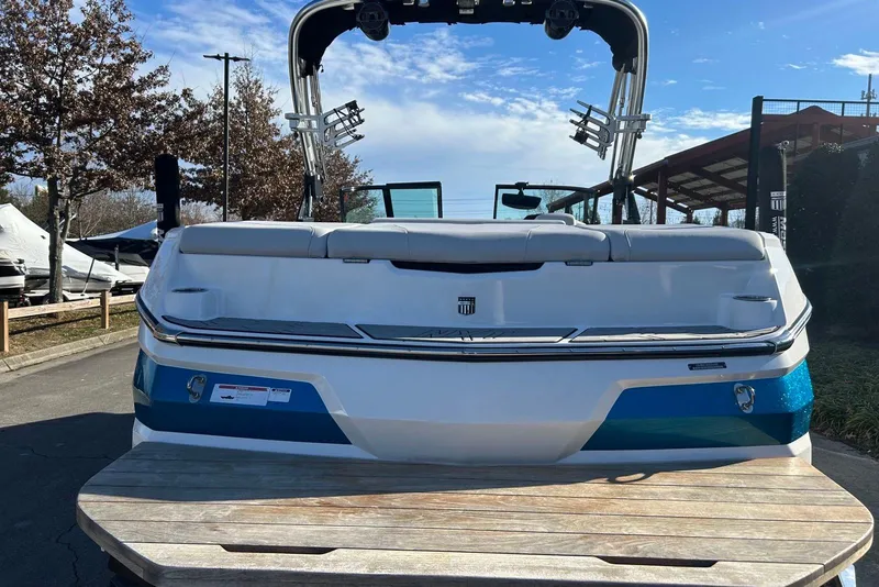 Slide: The Image of 2020 MasterCraft NXT22 boat rear view with blue accents and wakeboard tower. - 7