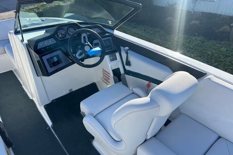 Slide: The Image of 2020 MasterCraft NXT22 boat interior with steering wheel and dashboard controls. - 9