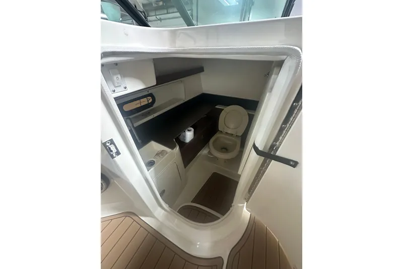 Slide: The Image of 2015 Sea Ray 290 Sundeck boat interior bathroom with toilet and storage. - 12