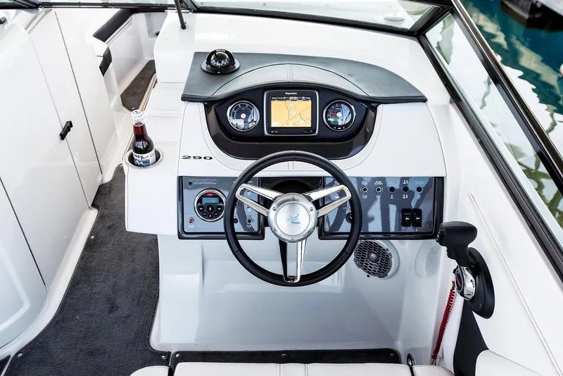 Slide: The Image of Manufacturer Provided Image: 2015 Sea Ray 290 Sundeck boat dashboard with steering wheel and navigation system. - 16
