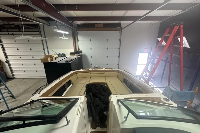 Slide: The Image of 2015 Sea Ray 290 Sundeck boat in a garage with open bow seating. - 3