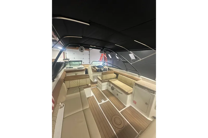 Slide: The Image of 2015 Sea Ray 290 Sundeck interior with tan seating and wood flooring. - 4
