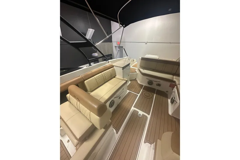 Slide: The Image of 2015 Sea Ray 290 Sundeck interior with tan seating and wood-style flooring. - 6