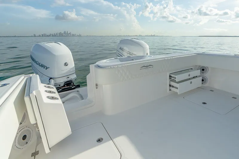 Slide: The Image of Manufacturer Provided Image: 2026 Invincible 33 Catamaran with dual Mercury engines on calm water, city skyline in background. - 14