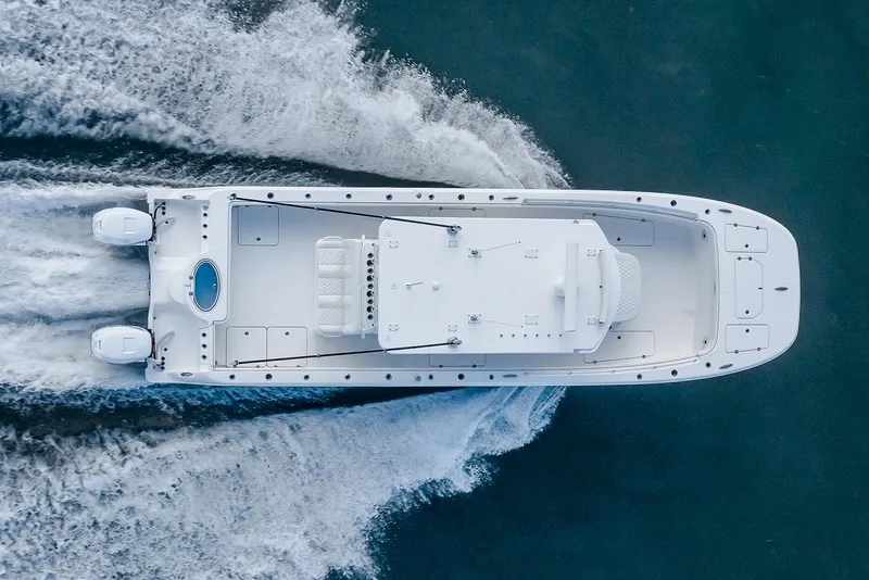 Slide: The Image of Manufacturer Provided Image: 2026 Invincible 33 Catamaran cruising on water, aerial view, showcasing sleek design and twin engines. - 3