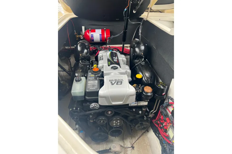 Slide: The Image of 2019 Sea Ray SLX 280 engine compartment with Big Block V8 and fire extinguisher. - 10