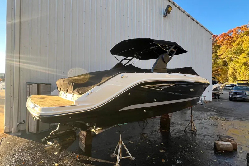 Slide: The Image of 2019 Sea Ray SLX 280 boat on stands, outdoor storage, sunny day. - 11