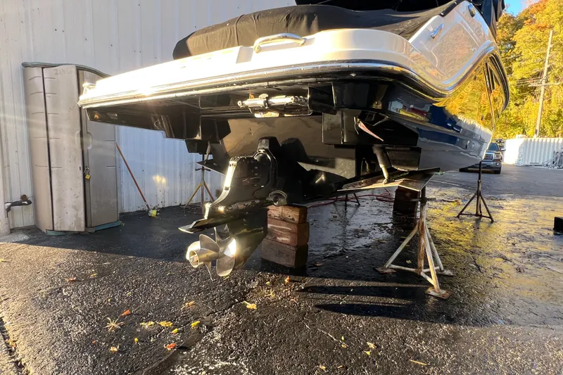 Slide: The Image of 2019 Sea Ray SLX 280 boat on stands, showing propeller and hull details. - 13