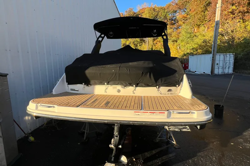 Slide: The Image of 2019 Sea Ray SLX 280 boat with covered deck, parked outdoors. - 14