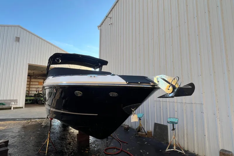 Slide: The Image of 2019 Sea Ray SLX 280 boat in storage, front view near warehouse. - 15
