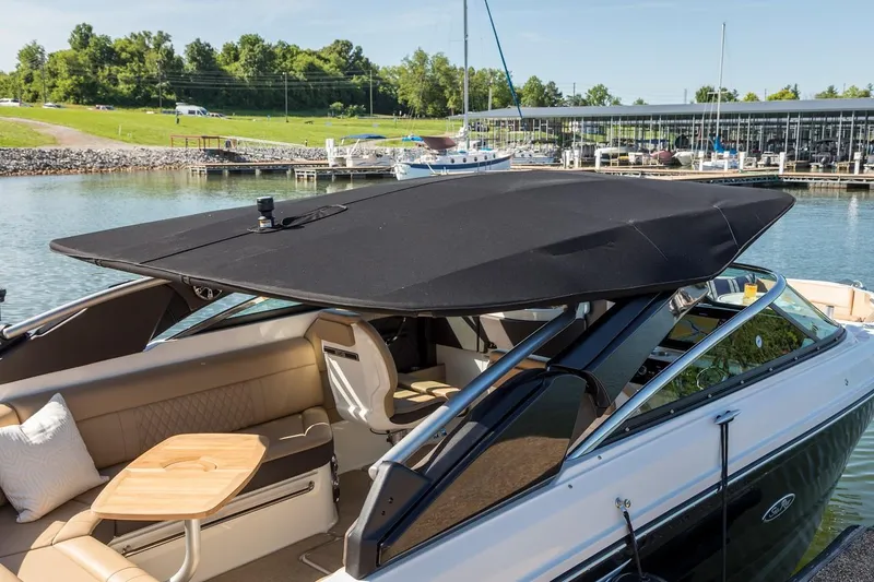 Slide: The Image of Manufacturer Provided Image: 2019 Sea Ray SLX 280 boat with black canopy docked at marina. - 16