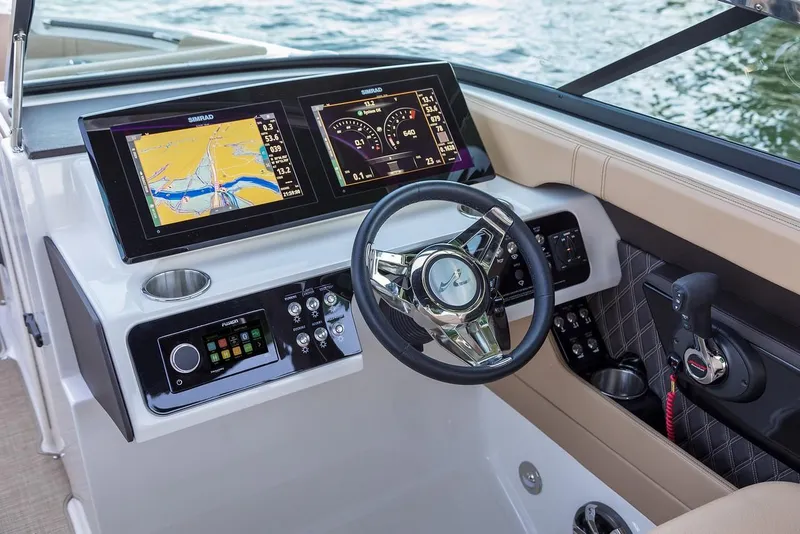 Slide: The Image of Manufacturer Provided Image: 2019 Sea Ray SLX 280 boat dashboard with dual Simrad displays and steering wheel. - 17