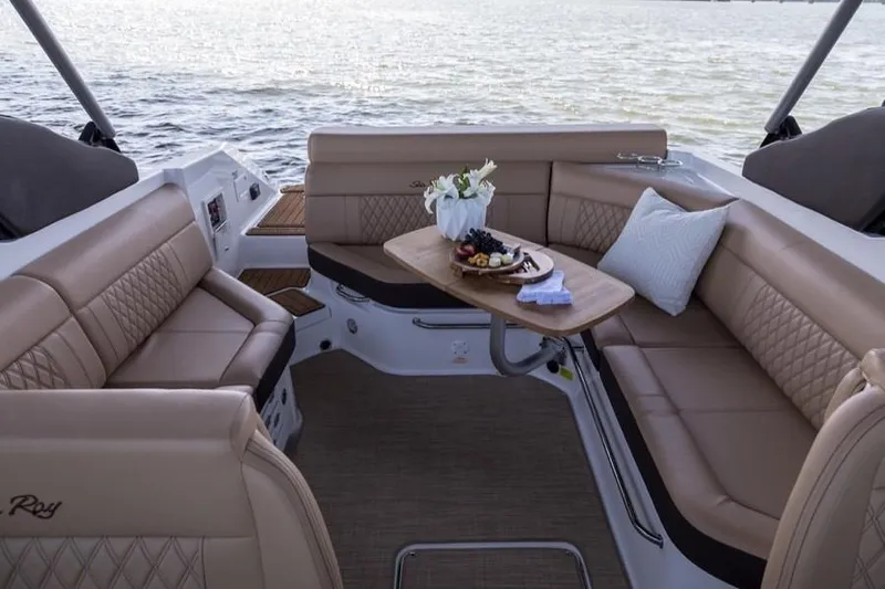 Slide: The Image of Manufacturer Provided Image: 2019 Sea Ray SLX 280 boat interior with luxurious seating and a table set for dining. - 19