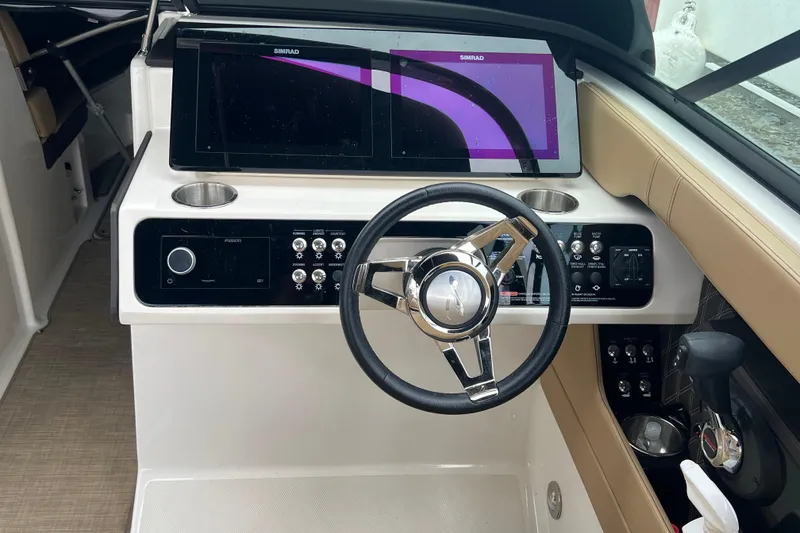 Slide: The Image of 2019 Sea Ray SLX 280 helm with modern controls and dual Simrad displays. - 2