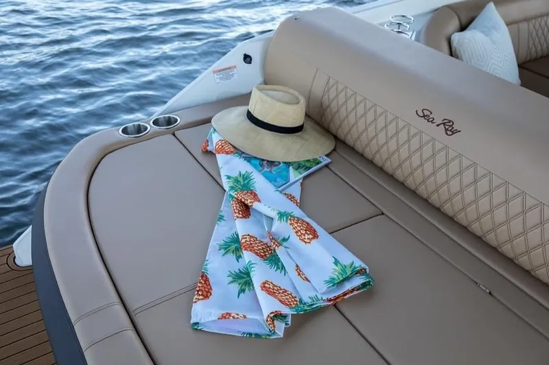Slide: The Image of Manufacturer Provided Image: 2019 Sea Ray SLX 280 boat with hat and pineapple towel on deck. - 21