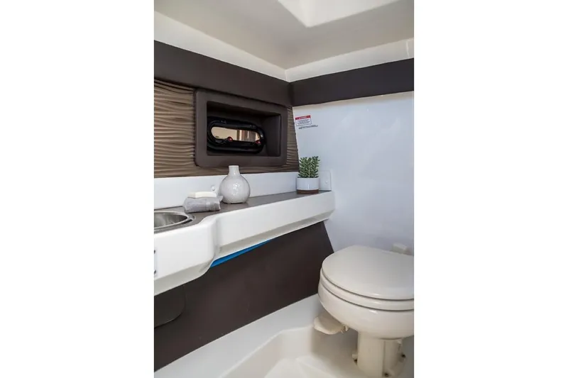 Slide: The Image of Manufacturer Provided Image: 2019 Sea Ray SLX 280 boat interior bathroom with sink and toilet. - 27