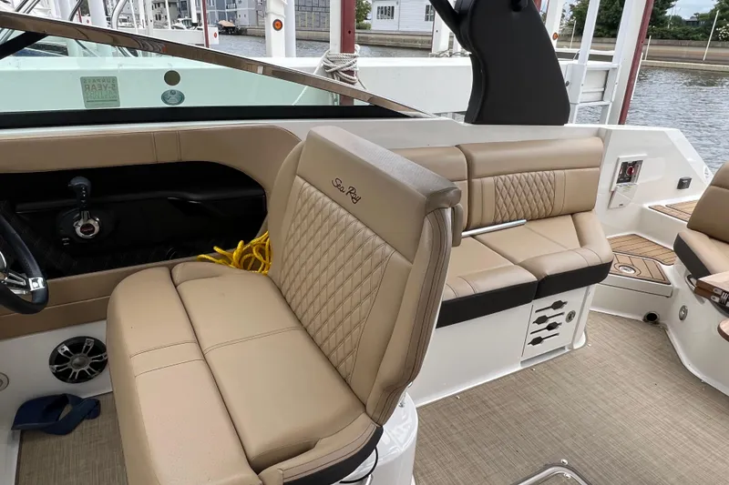 Slide: The Image of 2019 Sea Ray SLX 280 boat interior with beige leather seating and modern design. - 7