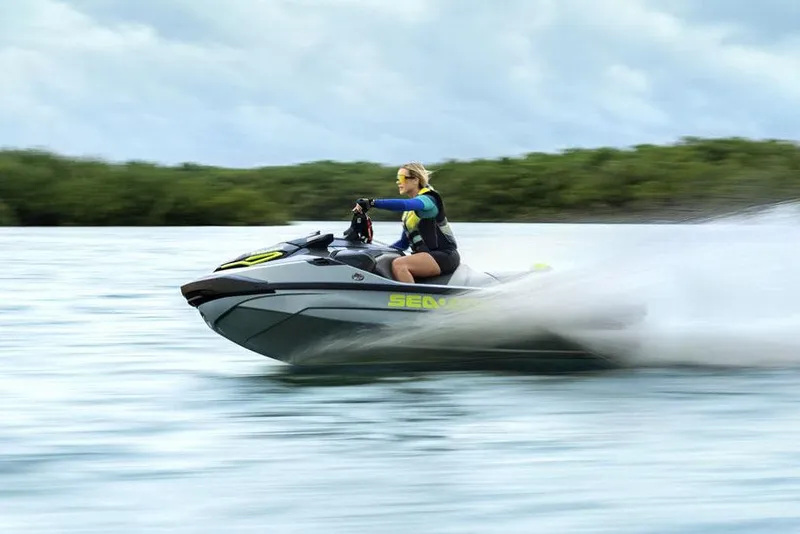 Slide: The Image of Manufacturer Provided Image: 2026 Sea-Doo RXT-X 325 jet ski speeding on water with rider. - 2