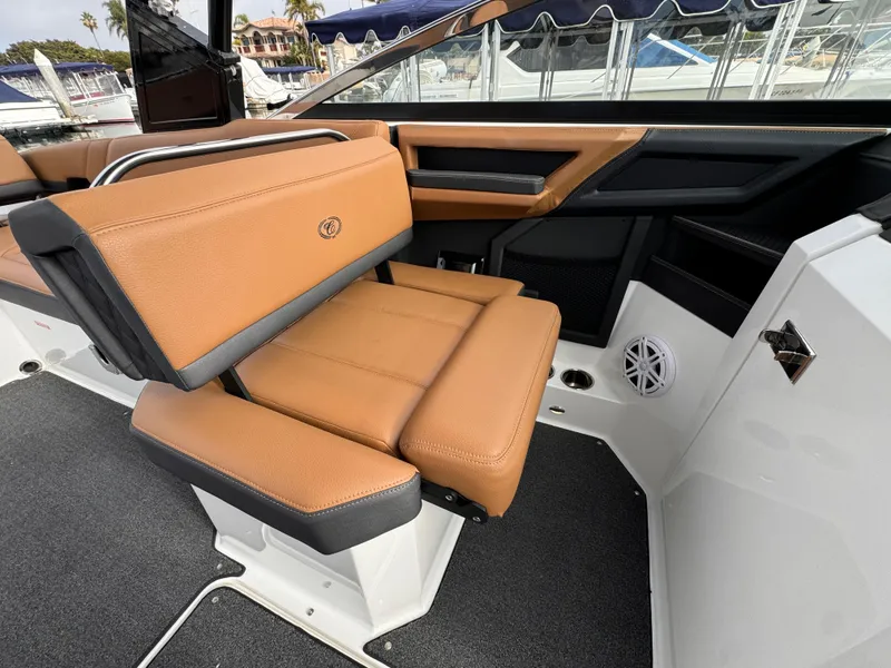 Slide: The Image of 2022 Cobalt R8 boat interior with tan leather seating and modern design. - 11